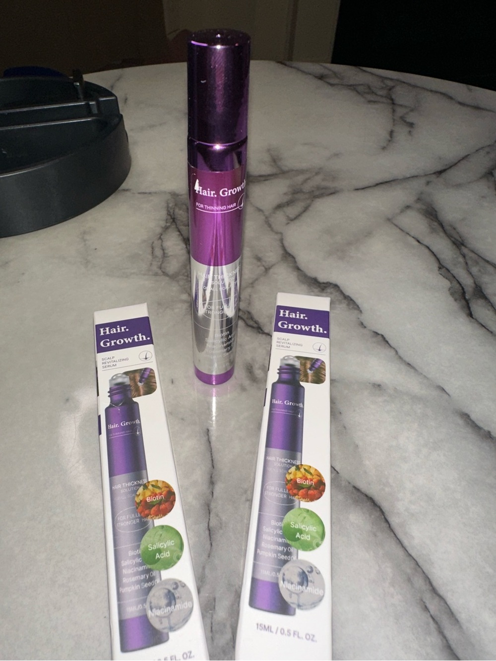 2 boxes Hair Thickening Serum features a roll-on applicator